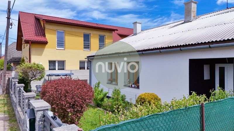 A family house in Košťany nad Turcom with a yard, fence, and natural greenery.