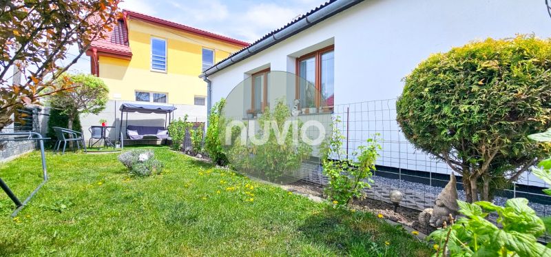 A family house in Košťany nad Turcom with a well-maintained garden and garden furniture.