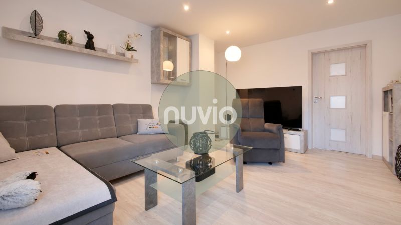 Living room in a family house with a wooden decor floor and a sofa.