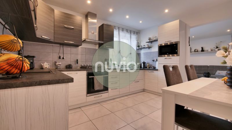 A kitchen in a family house with modern appliances and a dining table.