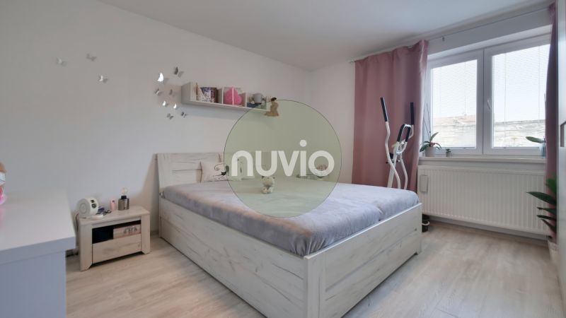A bright bedroom in a family house with a wooden decor floor and exercise equipment.