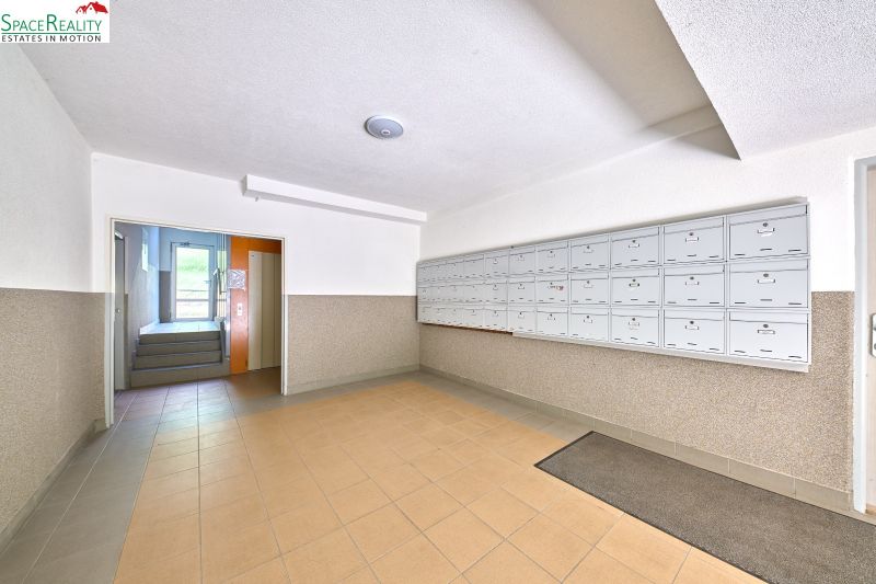 Lobby with mailboxes and entrance to the elevator in an apartment building.