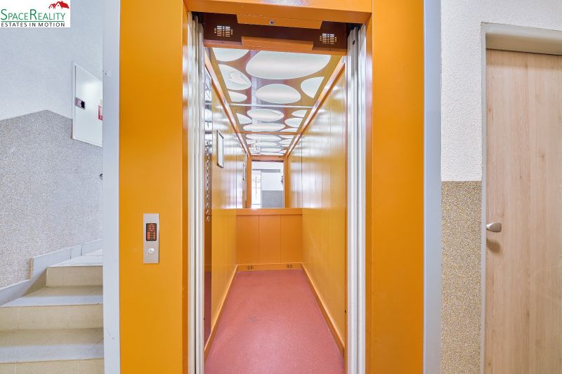 Yellow interior of the elevator next to the staircase, typical for Kyjevská in Bratislava - Nové Mesto.
