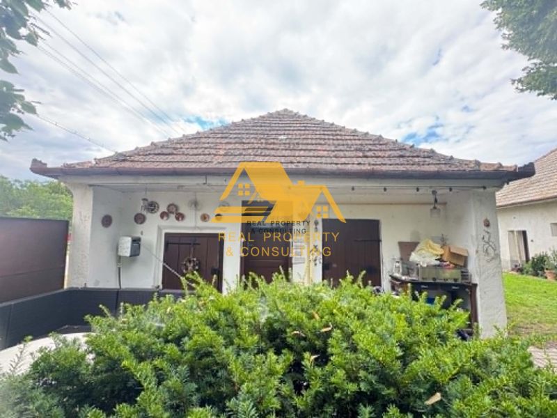 A family house in Imeľ on Imeľ Street with a classic sloped roof and decorations.
