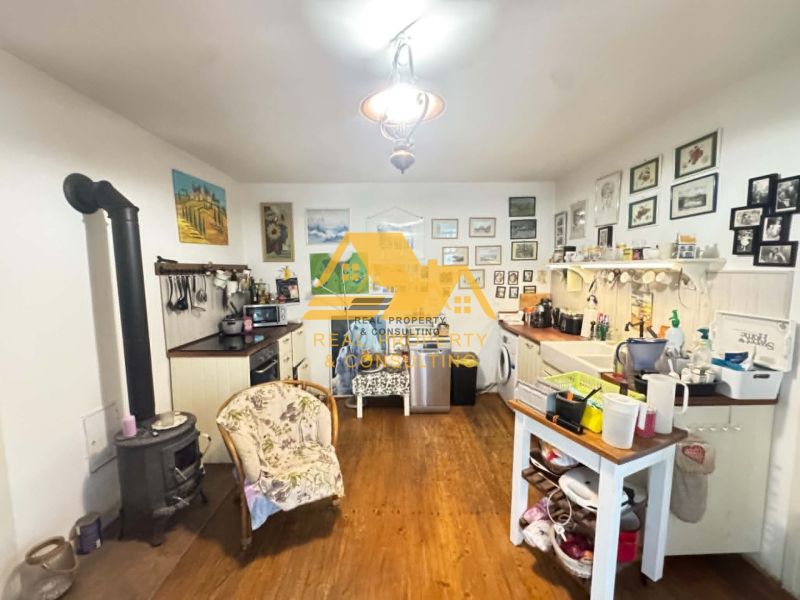 A kitchen in a family house with a wooden decor floor and lots of decorations.