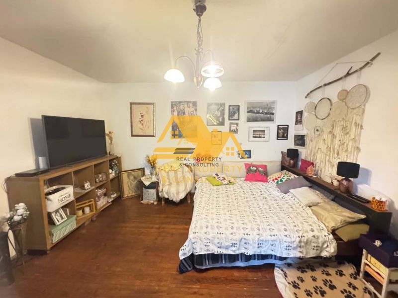 Bedroom with wooden decor, bed, and decorations in a family house.
