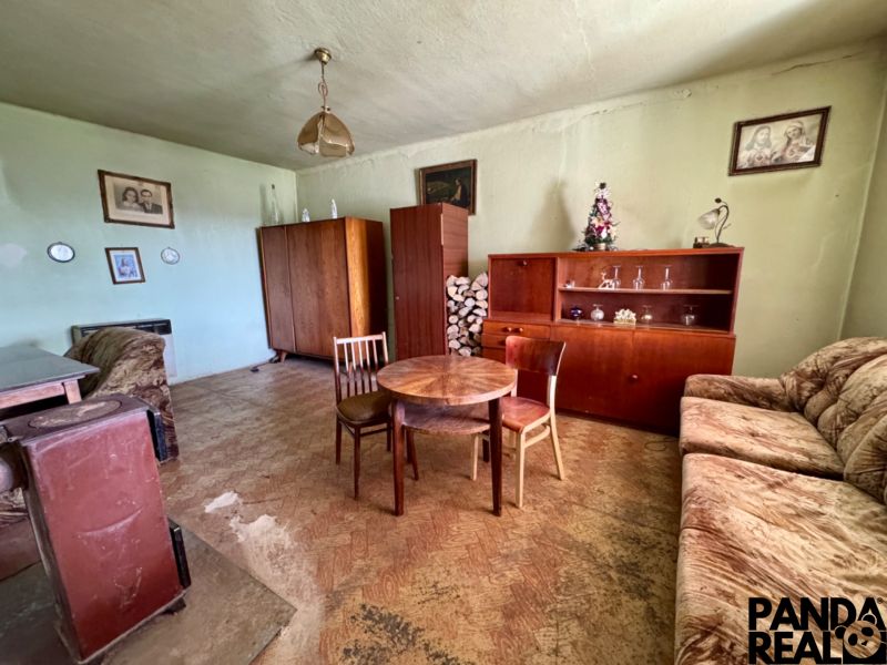 Living room in a family house with furniture and flooring featuring a wood decor.