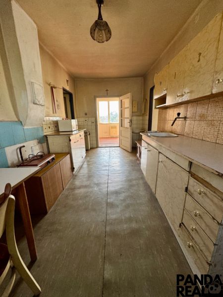 A kitchen room in a family house with a wooden decor on the floor.