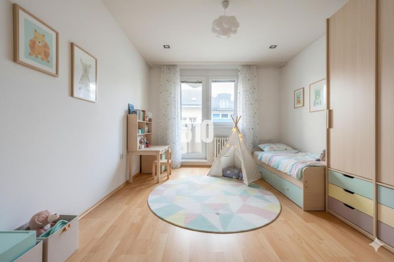 Children's room in a 4-room apartment with wood-decor flooring, canopy, and furniture.