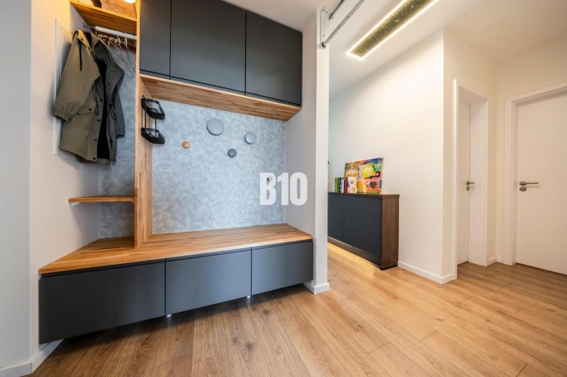 Hallway in a 3-room apartment with furniture and flooring featuring a wood decor.