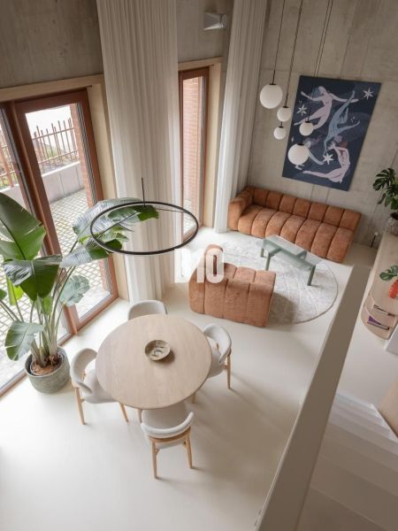 A bright living room with a round table and artificial flooring in a two-room apartment.