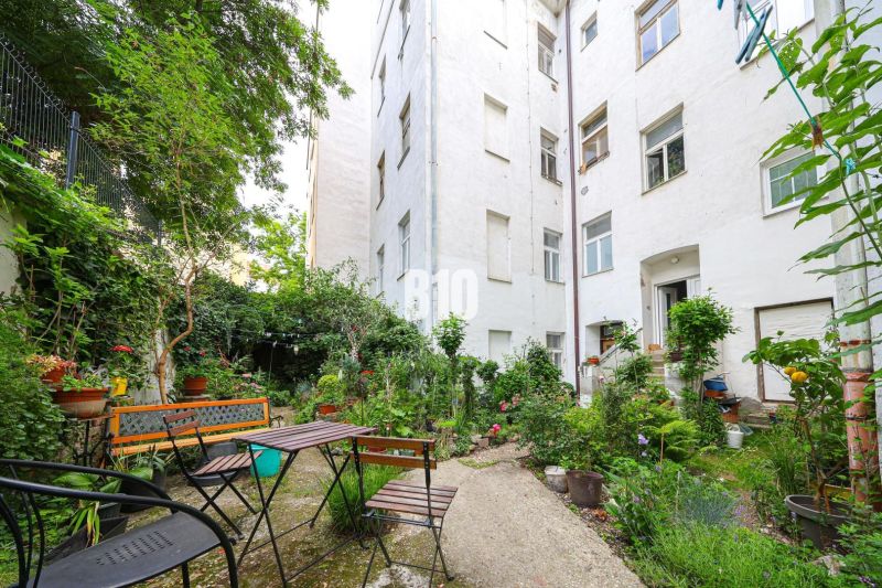 A flower garden with seating by a 2-room apartment on Kozia Street in the Old Town of Bratislava.