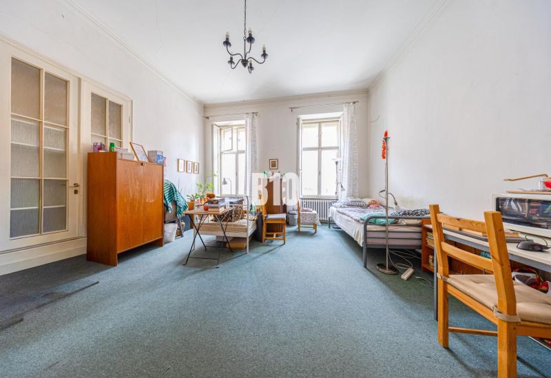 A spacious room with two beds and a carpet in a 2-room apartment.
