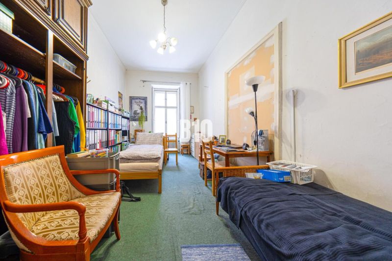 A room in a 2-room apartment with antique furniture and large storage space.