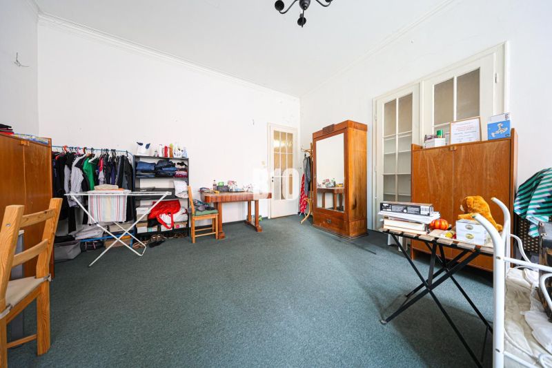 Living room in a two-room apartment with wooden furniture and a carpet.