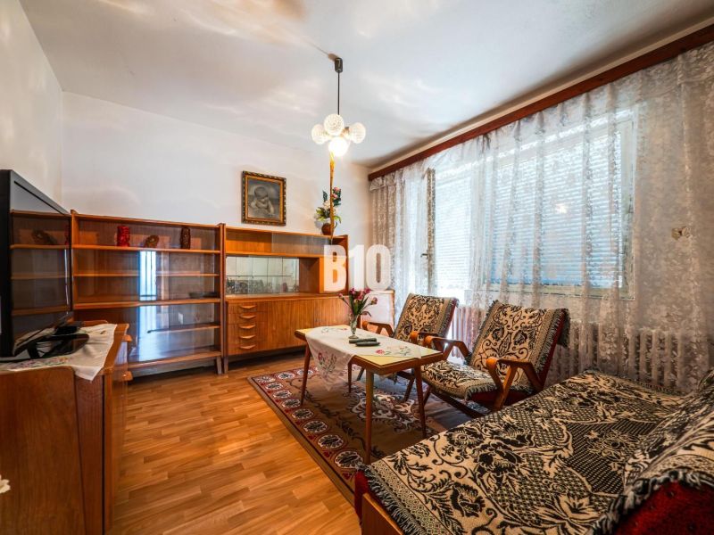 Living room in a family house with a wooden decor floor and vintage furniture.
