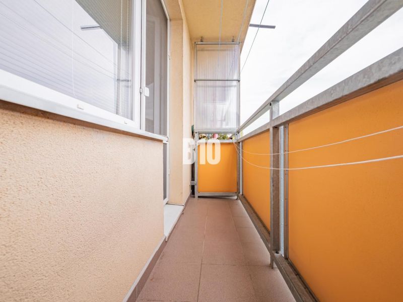 Balcony of a 3-room apartment on Ďumbierska Street in Nitra with orange railings.