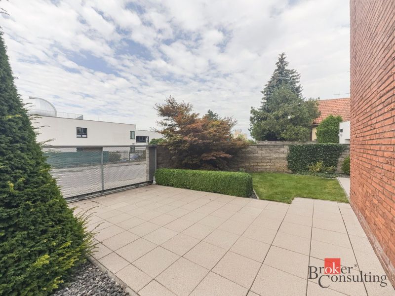 Courtyard with a terrace, greenery, and trees on Bárdošova Street, Bratislava-Nové Mesto.