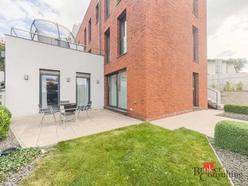 Modern terrace with outdoor seating by a brick house on Bárdošova Street, Bratislava-Nové Mesto.