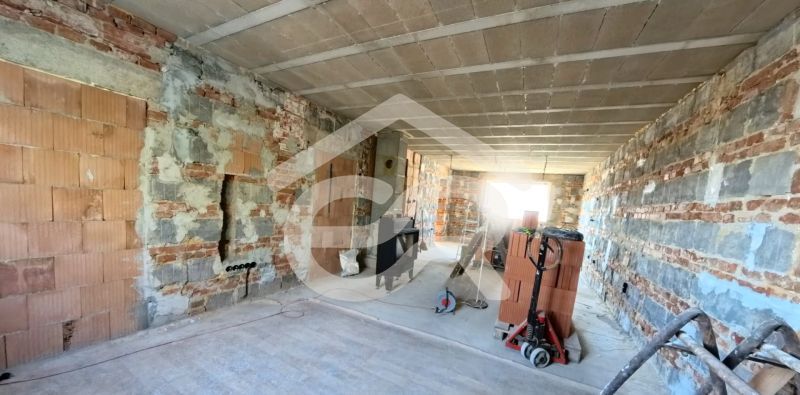 The interior of a family house under renovation with brick walls.