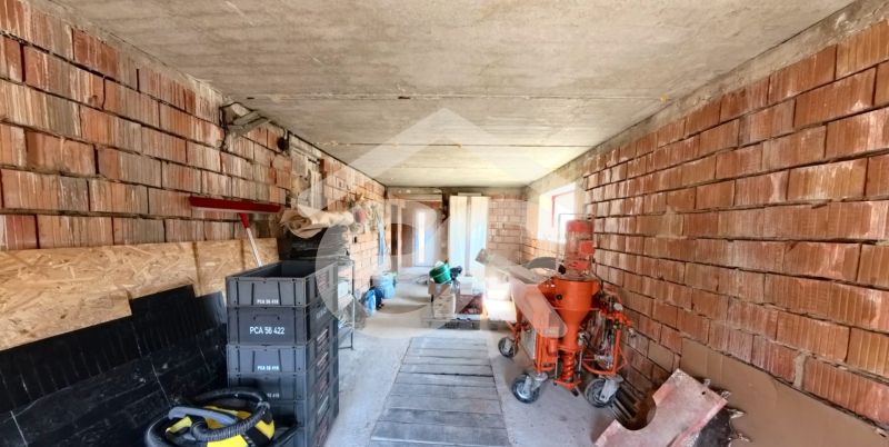 Interior of a family house with brick walls and building materials.
