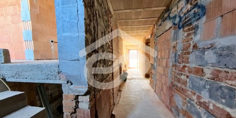 An interior in an unfinished state with brick walls in a family house.
