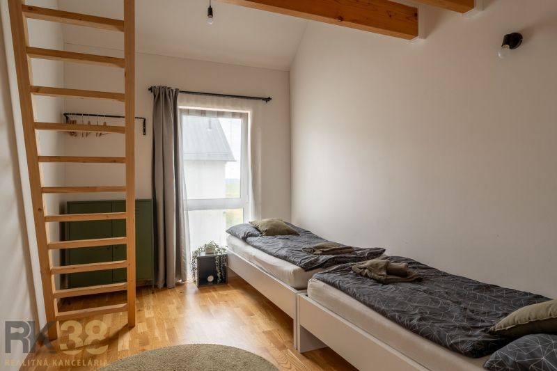 A room with a bright interior, beds, and a wooden decor floor in a 4-room apartment.