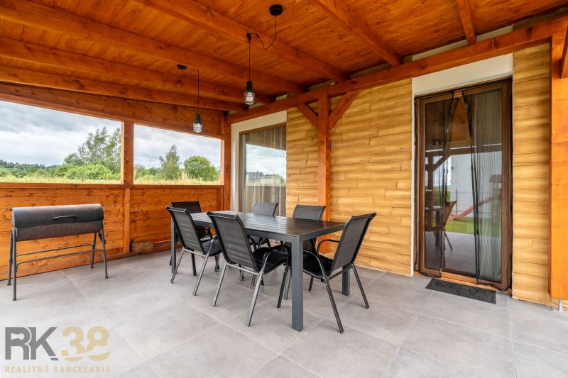 Terrace of a 4-room apartment with wooden decor and outdoor seating.