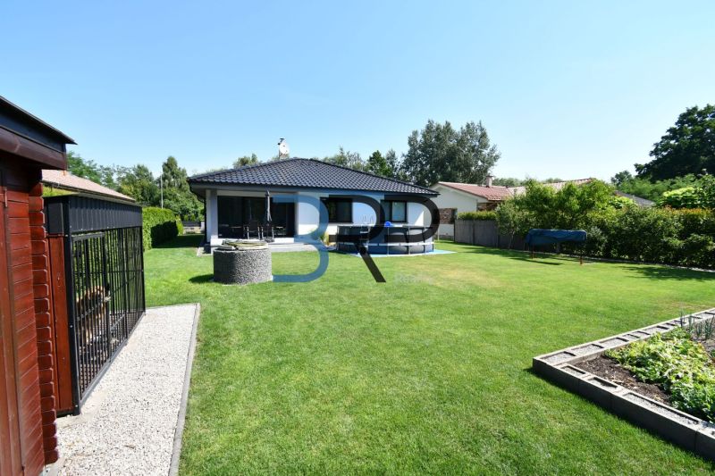 A family house in Šajdíkové Humence with a terrace, swimming pool, and well-maintained garden.