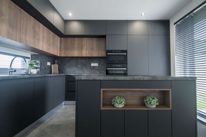 A kitchen in a family house with black furniture and wooden decor.