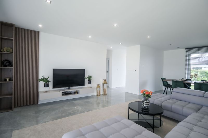 Living room in a family house with a TV on the wall and comfortable seating.