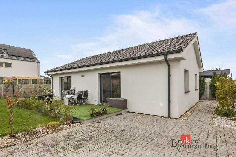 A family house in Bratislava-Podunajské Biskupice with a terrace, garden, and paved walkway.