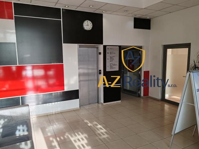 Office interiors with an elevator and a wall in red and black design.