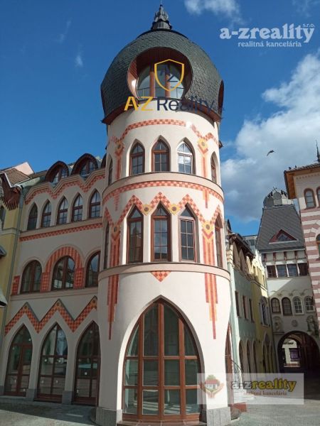 A historic building with rounded towers at the Courtyard of Europe in Komárno, commercial spaces.