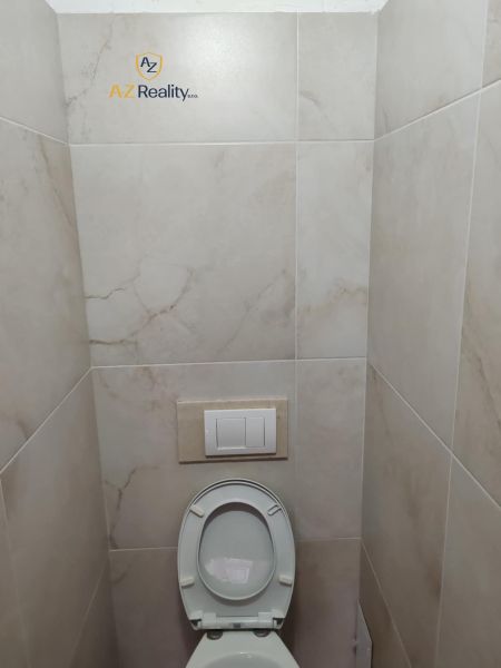 A restroom with tiled walls in commercial premises.