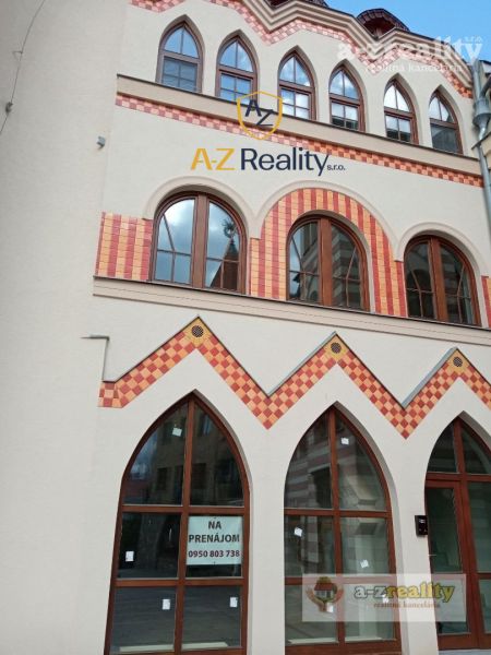 A building with colorful bricks and arched windows at the Courtyard of Europe in Komárno.