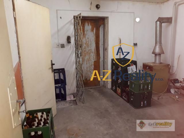 The interior of a building with beer crates and old doors, next to which there are doors.