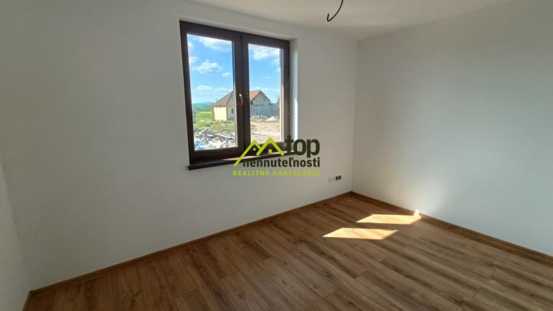 Interior of a family house with a wooden decor floor and a large window.