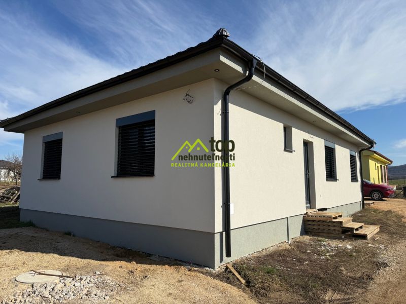 A family house in Oponice with a white facade and two windows.