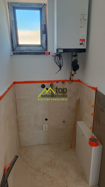 Room with a window and a boiler in a family house.