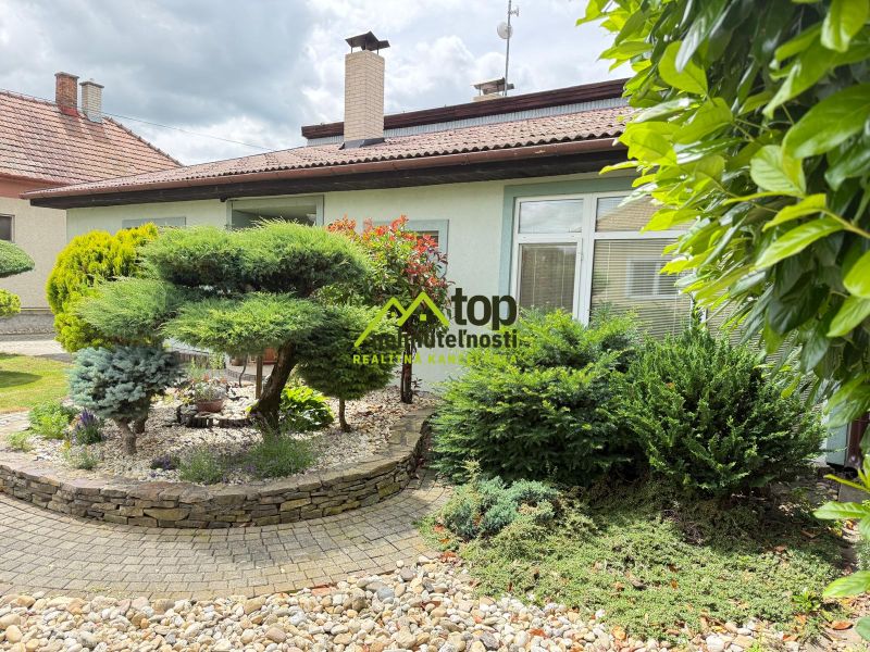 A family house in Chrabrany with a landscaped garden and a raised rock bed.