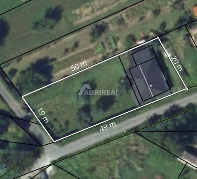Aerial view of the property with a family house in Ružiná, with its dimensions marked.