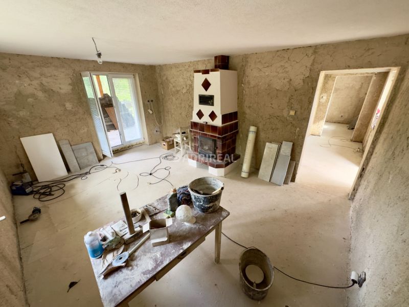 Interior of a family house with a fireplace and preparation for renovation.