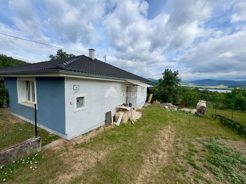 A family house in Ružiná with a grassy plot and a view of the surrounding countryside.