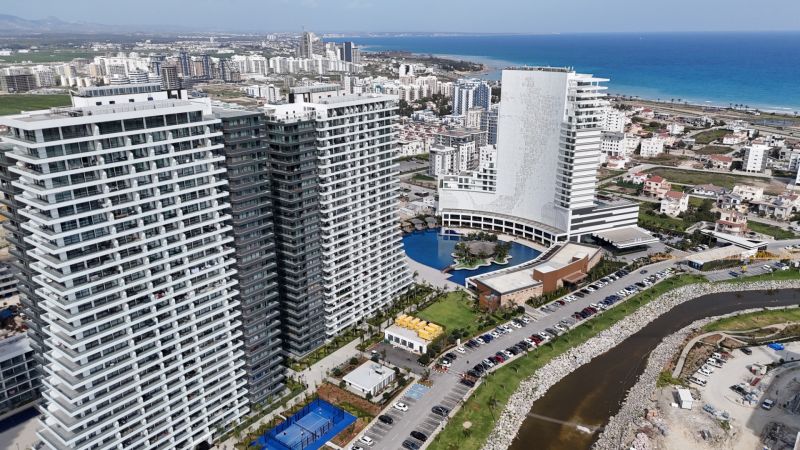 Apartment buildings and coastline in Agia Eirini, the surroundings are adorned with residential complexes.