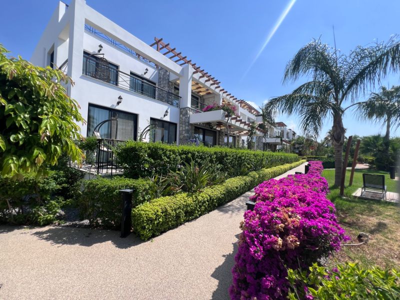 A building with a garden and flowers in the city of Agia Eirini, ideal for a 2-bedroom apartment.