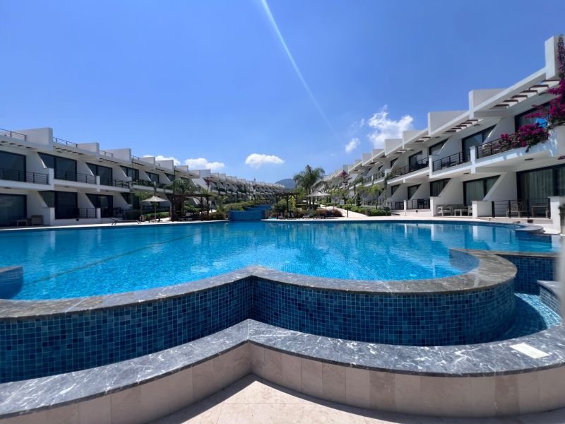 The apartments in Agia Eirini are surrounded by a large pool with clear blue water.