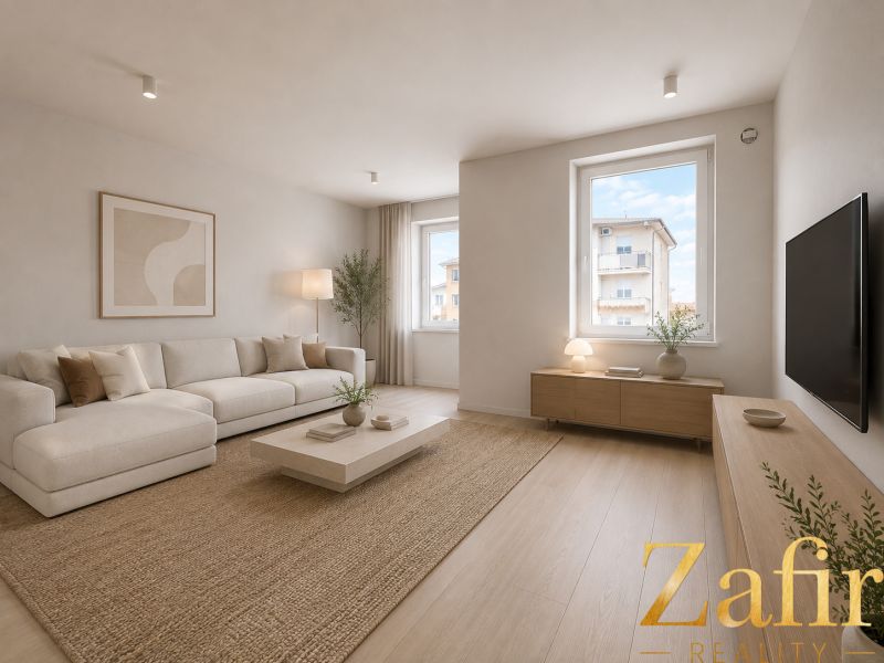 Living room with a cream sofa, wooden decor flooring, and subtle decor.