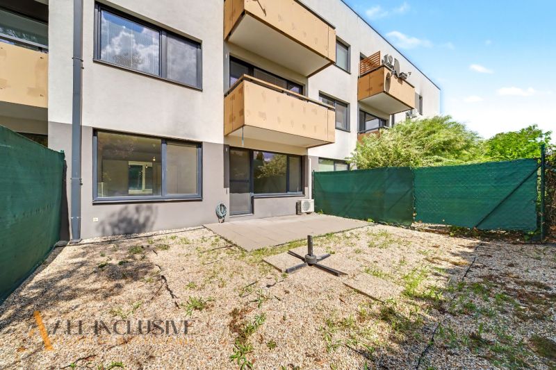 Exterior of a 2-room apartment in Dunajská Lužná with a terrace and green fencing.