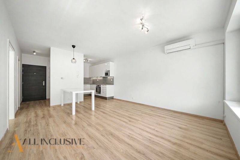 A bright kitchen interior in a two-room apartment with a wooden decor floor.